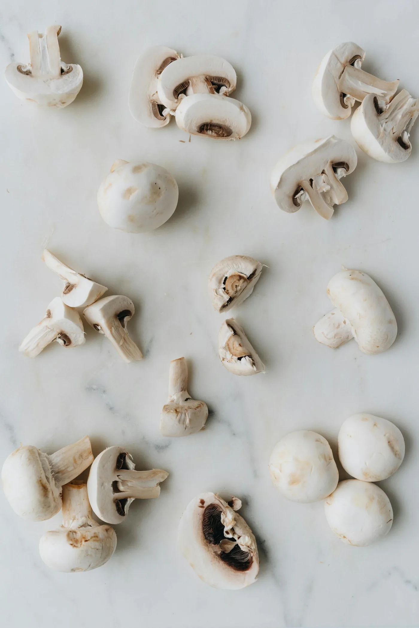Precisely portioned mushroom pieces on a marble surface